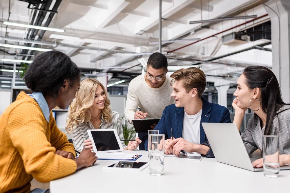 Image of employees working and having a meeting using their personal devices